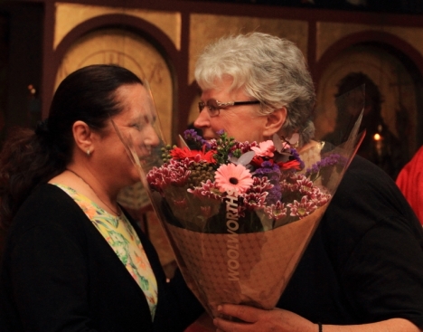Anthia Falekkos gives Val Hayes a bunch of flowers on behalf of the parish of St Nicholas